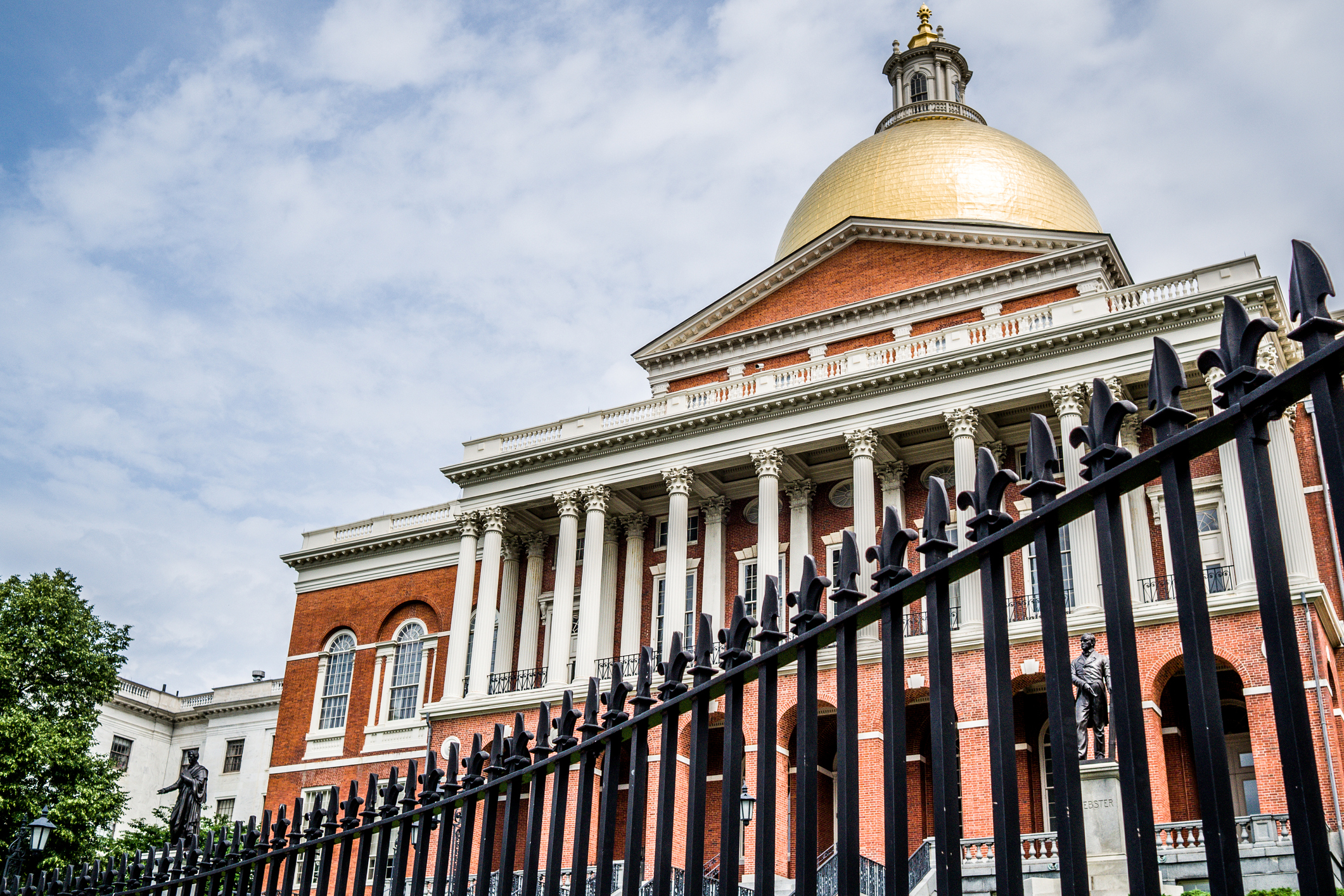 Massachusetts State House The Massachusetts State House stands behind an iron fence in Boston, MA.